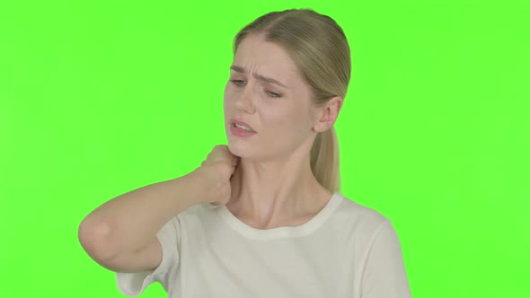 Tired Young Woman Yawning on Green Background