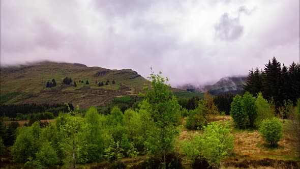 Cinematic timelapse of clouds over scottish highlands during golden hour