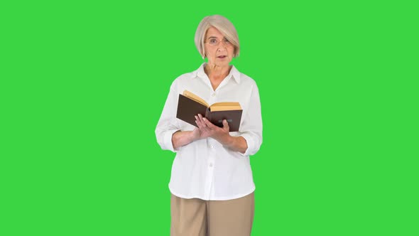 Senior Lady Woman Reading Old Book Out Loud on a Green Screen Chroma Key