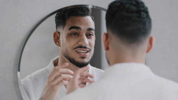 Funny Arabian Indian Bearded Man Speaking to Reflection Looking in Bathroom Mirror