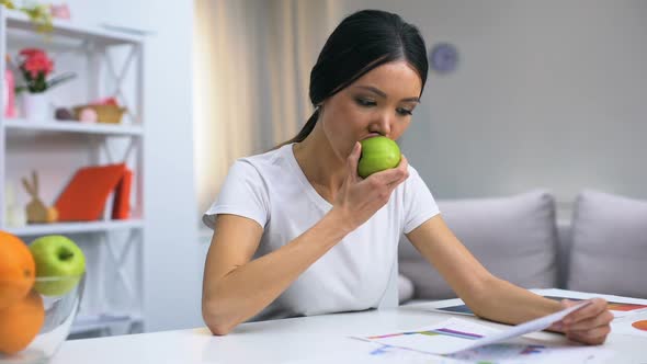 Female Designer Working at Home Feeling Dental Pain While Biting Fresh Apple