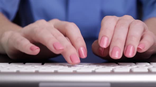 Female Hands Typing on White Keyboard