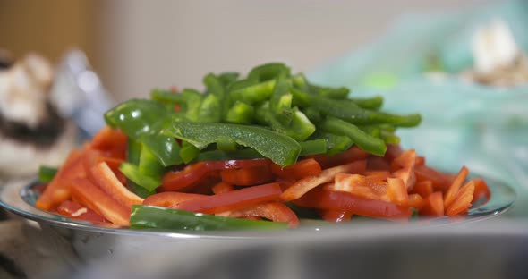 Cut Green and Red Peppers in a Bowl