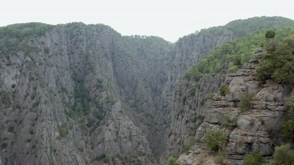 Drone Video of a Canyon in the Rocky Mountains with Peaks