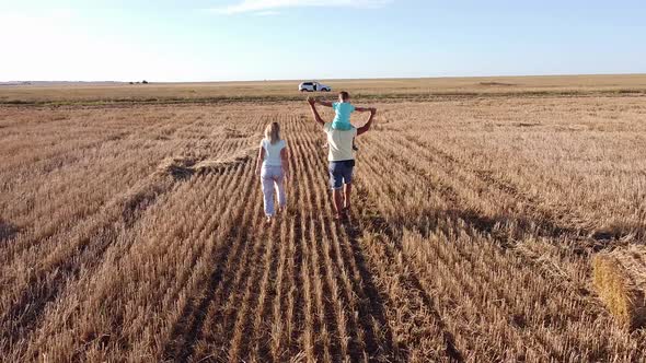 The Family Travels By Car They Enjoy Nature Walking in a Field in the Steppe Area