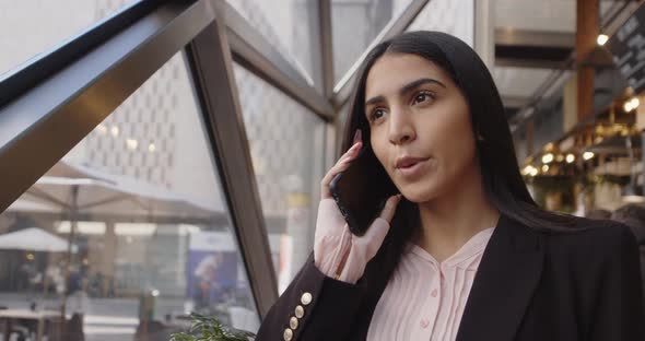 Smiling Young Business Woman Professional Talking on Phone Standing in Front of Window Happy