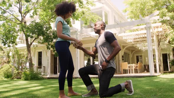 Happy mixed race couple enjoying in the garden during a sunny day