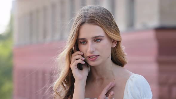 Frustrated Angry Millennial Woman Talking on Phone Outdoors Outraged Young Girl Holds Cellphone