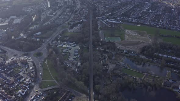 Stable wide drone shot of long straight railway in suburban UK Watford London