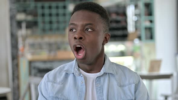 Portrait of Sleepy Young African Man Yawning