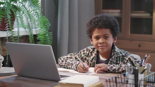 Portrait Of Cute Afro Boy Studying At Home