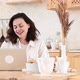 a Young Attractive Woman Sits at a Table in Her Kitchen and Talks Through a Video Conference - VideoHive Item for Sale