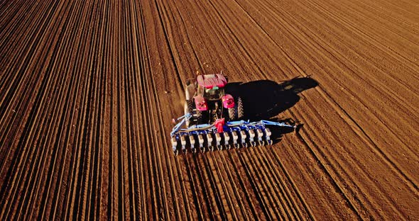 Seed drill on tractor sowing soybeans