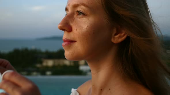 Smiling Woman Enjoy Sunset View and Put on Face Medical Mask Prevent Coronavirus