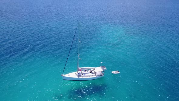 Tropical fly over island view of a paradise sunny white sand beach and blue sea background in best q