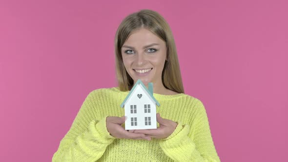 Beautiful Young Girl Holding Model House Pink Background