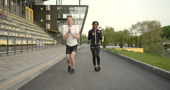 Interracial Couple Exercising Together in the Park