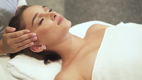 Young Woman Spending Free Time in Spa Salon on Massage