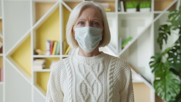 Safety and Pandemic Concept - Portrait of Senior Woman Wearing Protective Medical Mask for