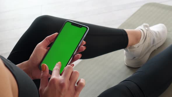 Green Screen Smartphone in Hands of Sports Woman, Close-up