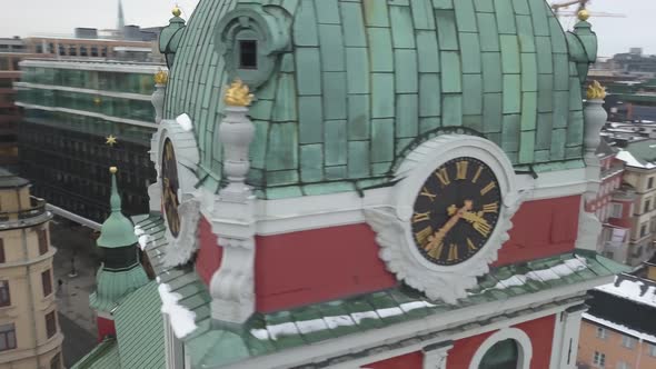 Drone rotating around famous tower of St James' Church in Stockholm, Sweden while flying backwards.