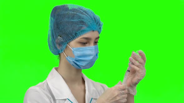 Young Woman Doctor Filling a Syringe with Vaccine