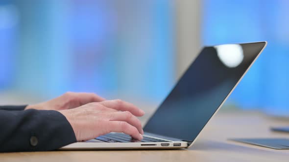 Side View of Businesswoman Typing on Laptop 