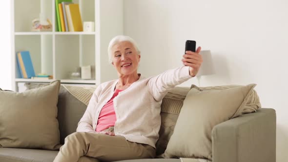 Senior Woman with Smartphone Taking Selfie at Home 