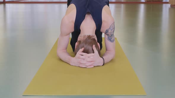 a Young Handsome Man Is Engaged in Gymnastics