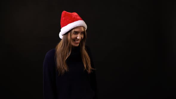 A girl taking off her Santa hat