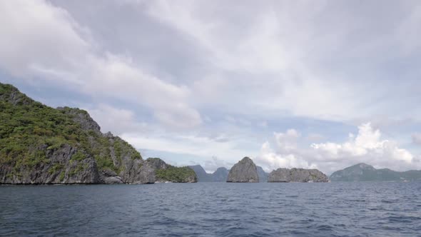 Sailing towards limestone cliffs and islands in El Nido, Palawan, the Philippines in ultra slow moti