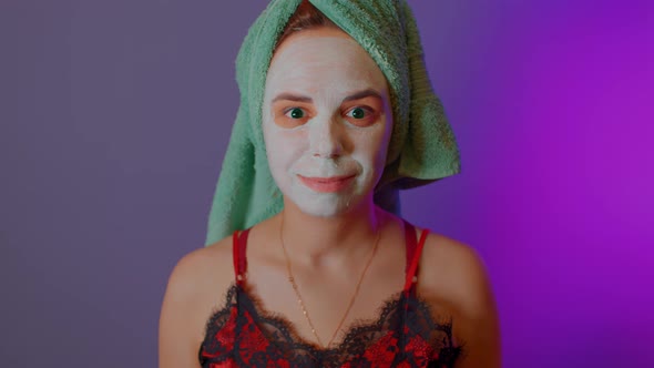 Young Woman with Towel on Head and Mask on Face After Shower Procedures