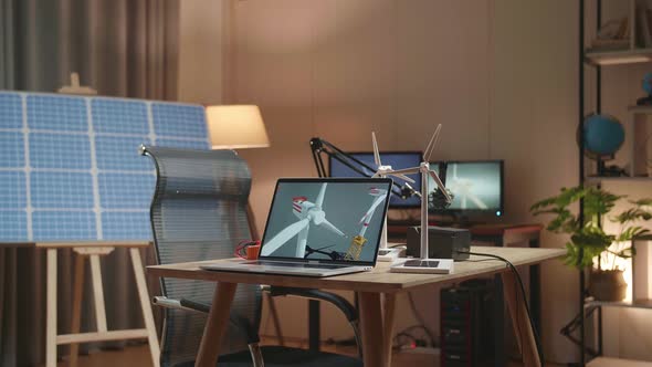 Laptop Showing Wind Turbine On The Table Next To The Solar Cell At The Office