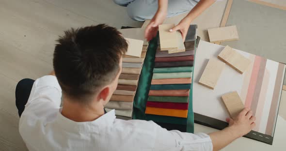 A Young Couple Picks Up Fabric and Wallpaper to Repair Their Home