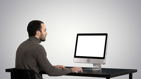 Man typing on the computer on gradient background