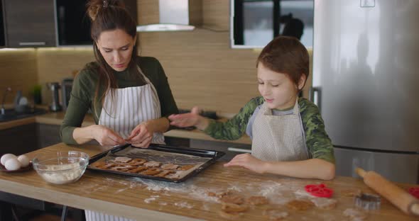 Happy Mother and Her Little Toddler Baby Boy Son Spread Cookies on a Baking Sheet