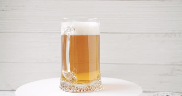 Craft Full Beer Into the Large Glass Beer Mug On a White Background