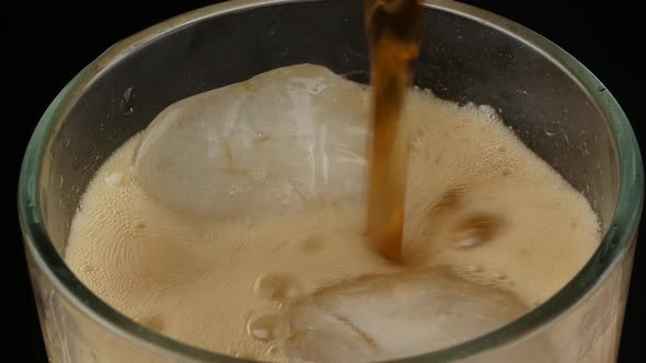 Pouring cola soda with ice and bubble. cold drink beverage