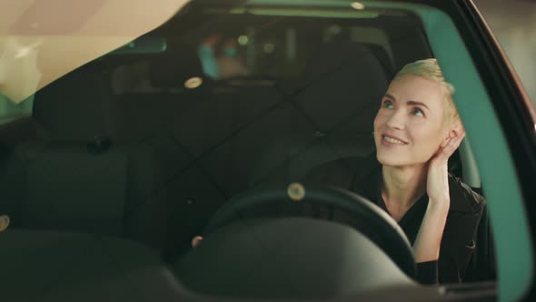 Girl Chooses New Car at Car Dealership