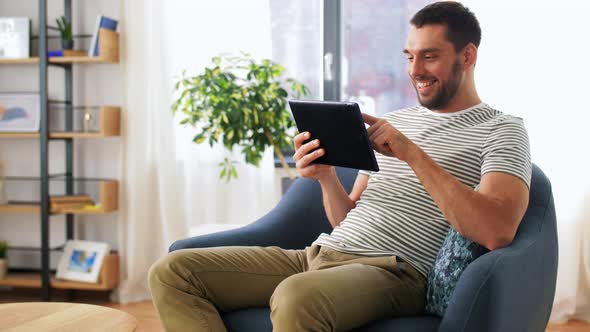 Smiling Man with Tablet Pc Computer at Home