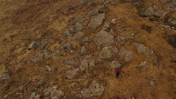 Drone Flight Over Hiking Man In Rugged Landscape