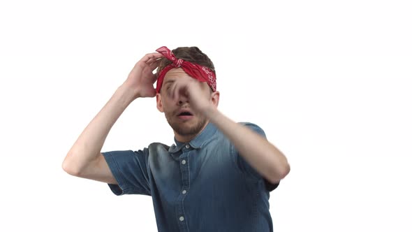 Handsome Bearded Male Model with Red Bandana Jumping Ambushed and Looking Scared Touching Heart As