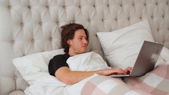 Man Lying in the Bed with Laptop, Sighs Tiredly and Slams Laptop, Go To Sleep