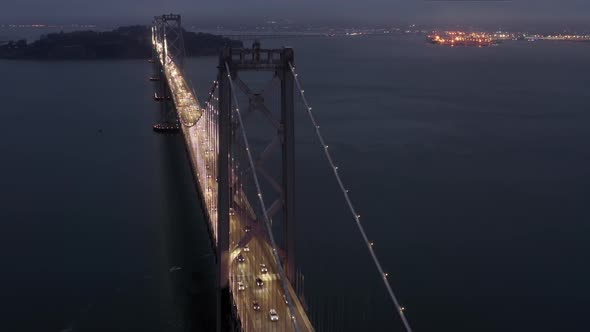 People Are Driving By Scenic Cable Bridge at Night.  San Francisco Night Scene