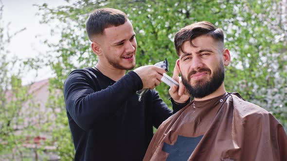 In Front of the Camera One Barber Man Doing a