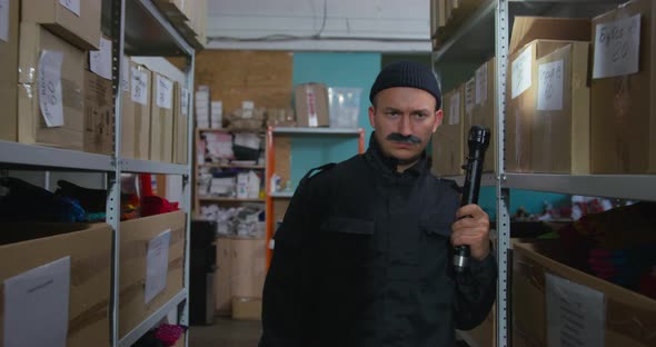 Man with False Mustache Acts Like Thief Observing Storeroom