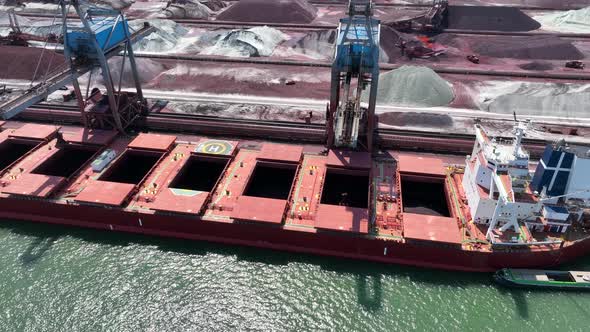 Cranes Unloading a Bulk Carrier Ship at Port