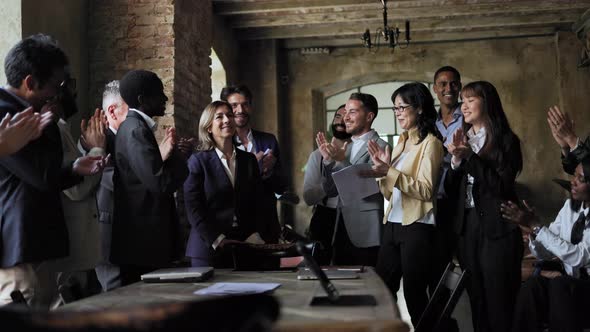 Diverse business people celebrating together inside bank office