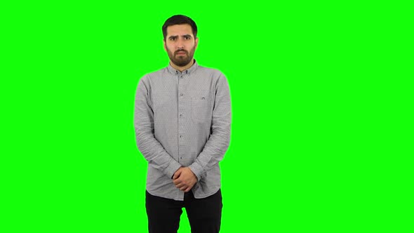 Brunette Guy in Anticipation of Worries, Then Guilty Hides His Eyes. Green Screen
