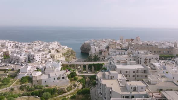 Aerial footage rotating around bridge and beach in Polignano a Mare, Italy.